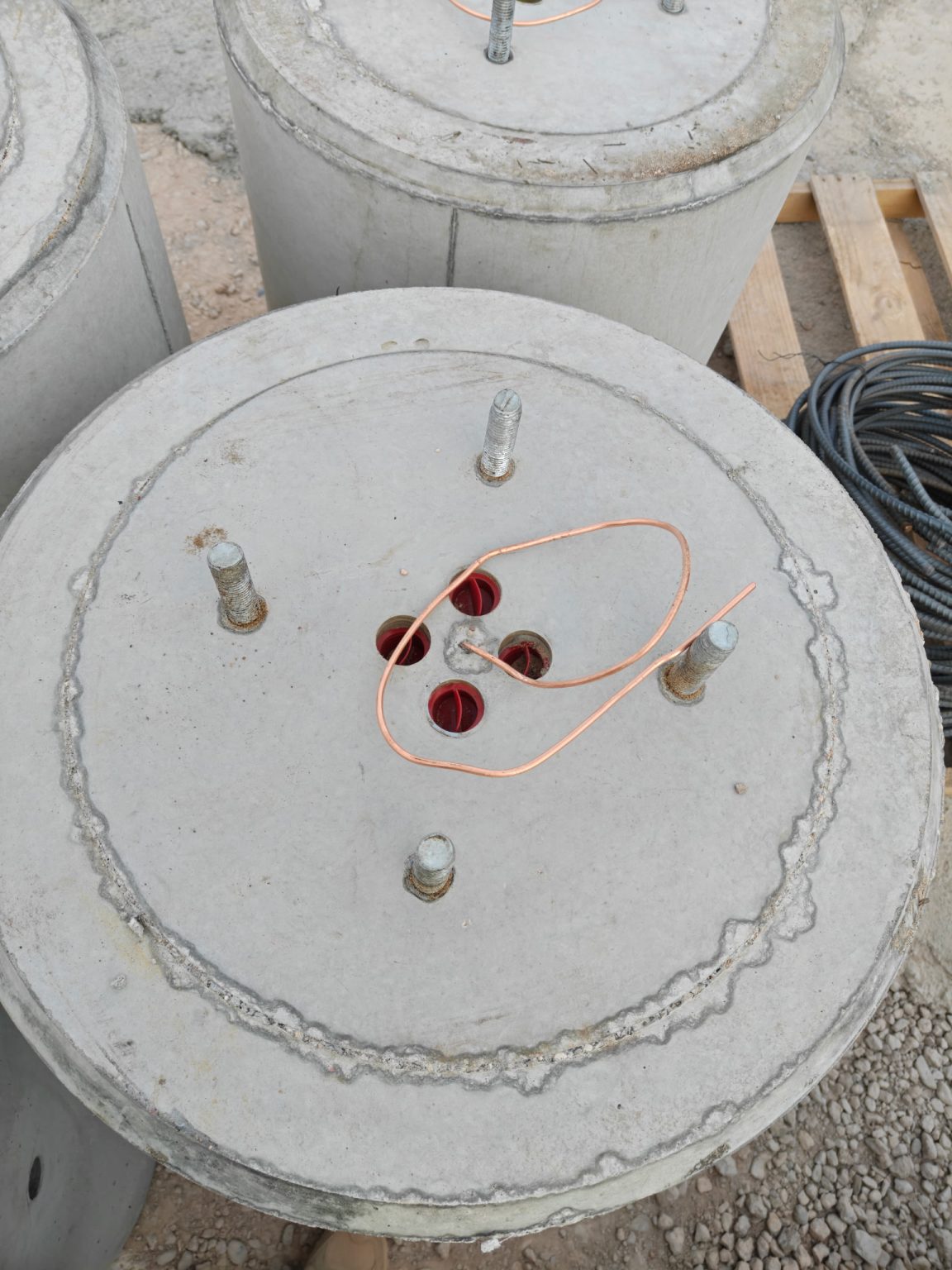 Light pole base top showing anchor bolts and conduit openings