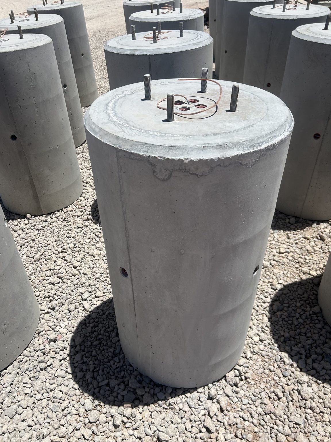 Precast concrete light pole base with cast-in anchor bolts